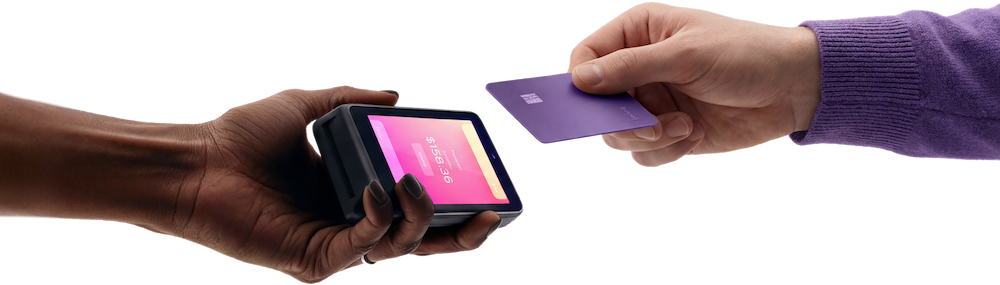 Hands tapping credit card on card reader