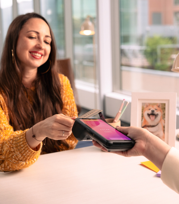 A merchant accepting an in-person card payment with Helcim