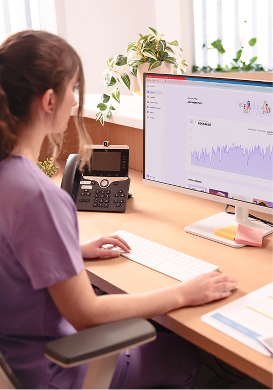 Dental staff reviewing patient forms with Helcim terminal nearby
