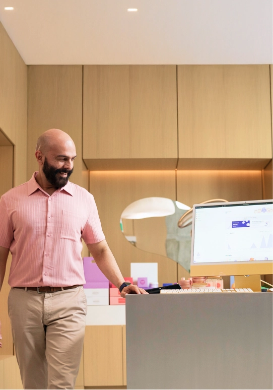 Office professional reviewing Helcim payment dashboard on desktop computer