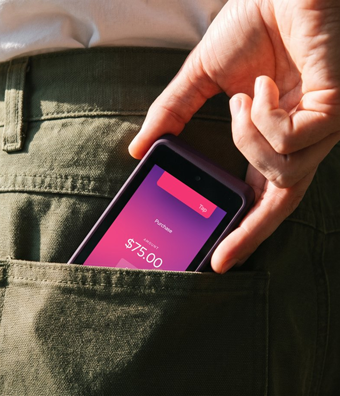 Merchant accepting a payment on a smartphone tucked in a back pocket