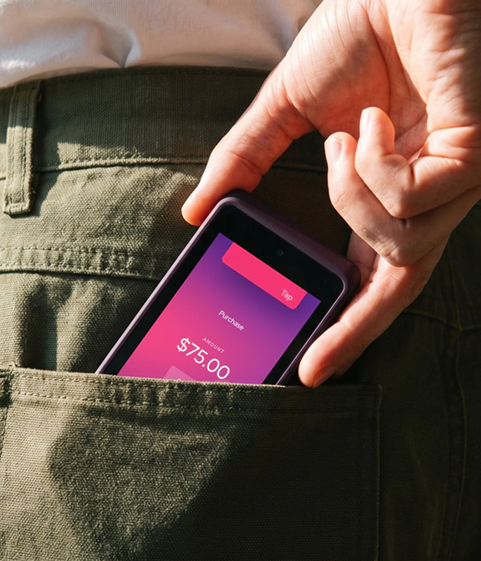 Merchant accepting a payment on a smartphone tucked in a back pocket