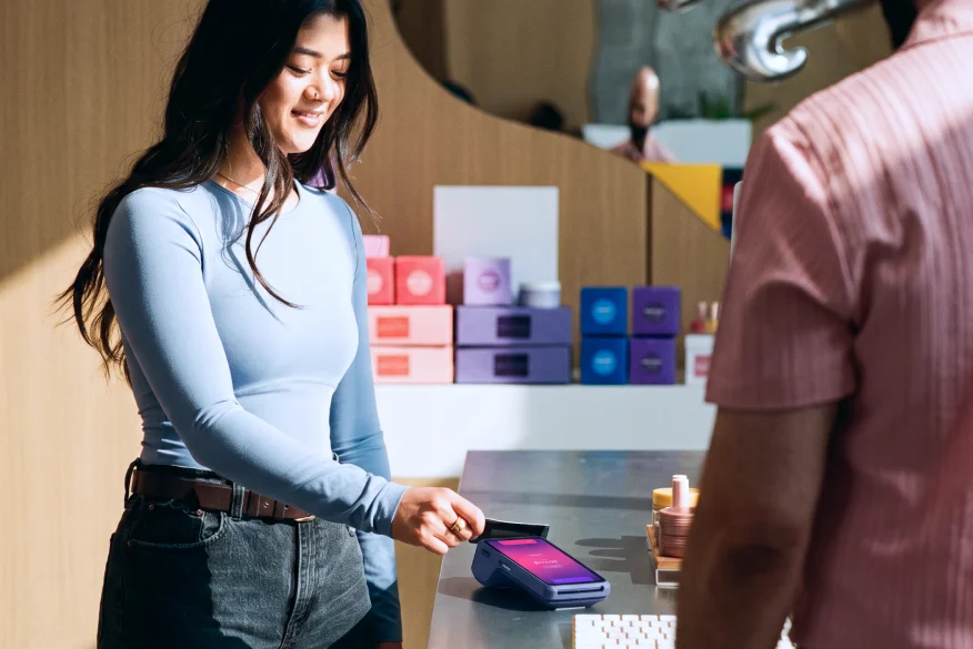 A merchant taking a tap payment at their counter