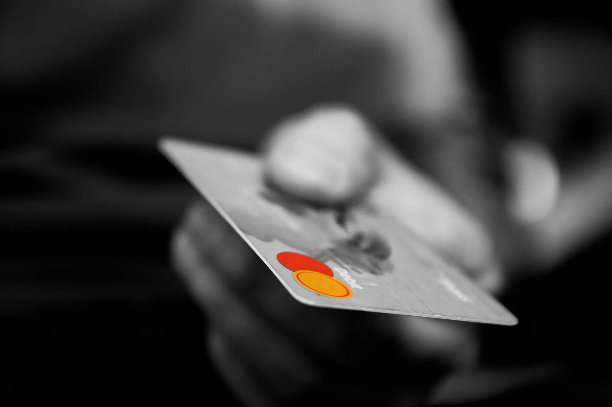 A hand holding a Mastercard