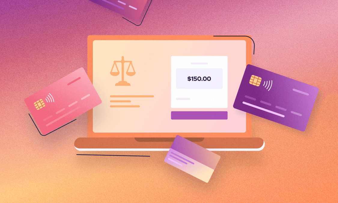 A laptop with a payment UI surrounded by credit cards