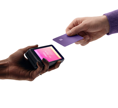 Hands tapping credit card on card reader