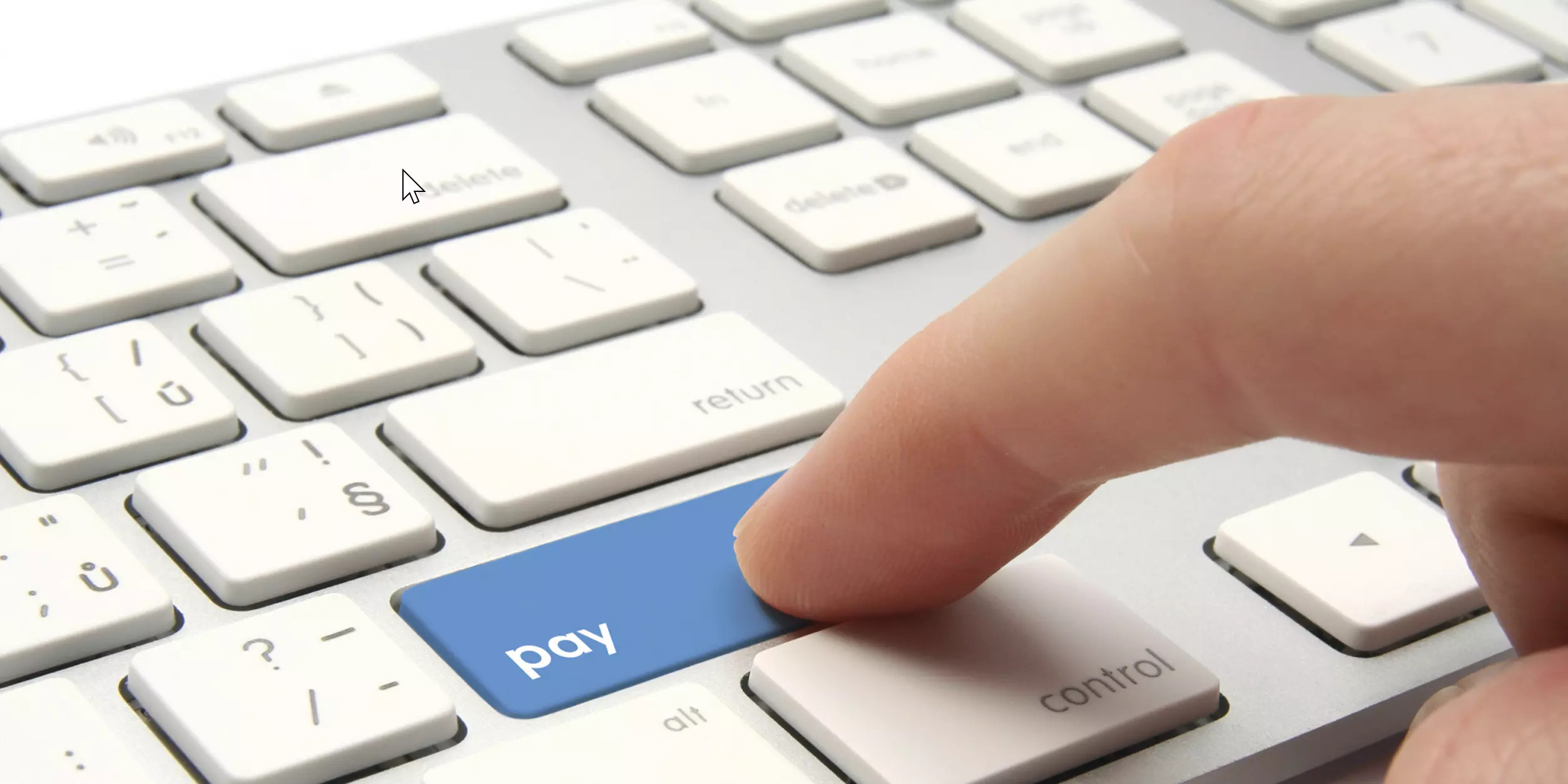 person hitting the pay button on a keyboard