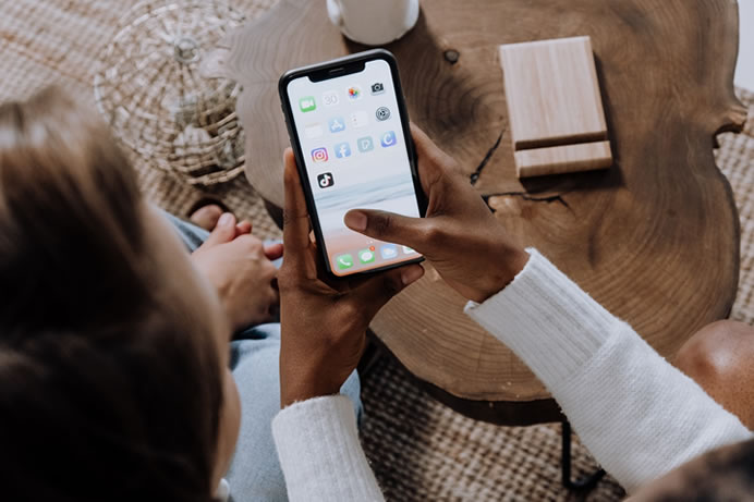Itwo people looking at an apps on an iPhone