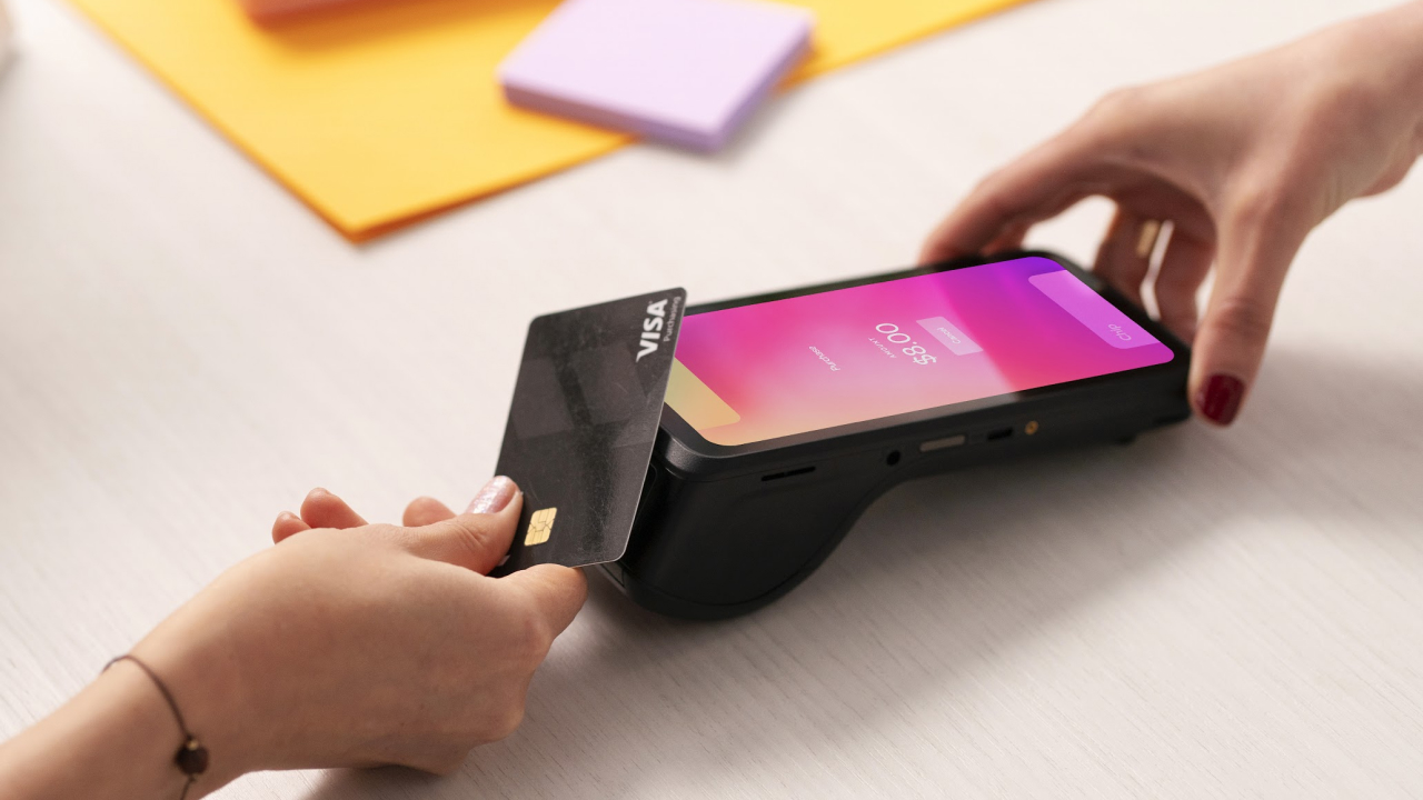 a person holding a Helcim Smart Terminal