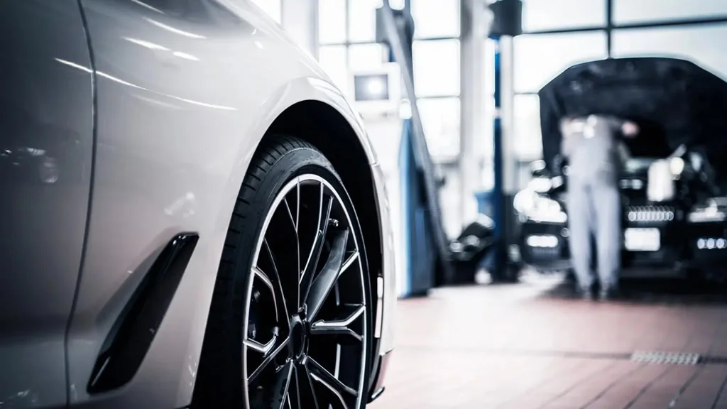 Two cars in an automobile shop