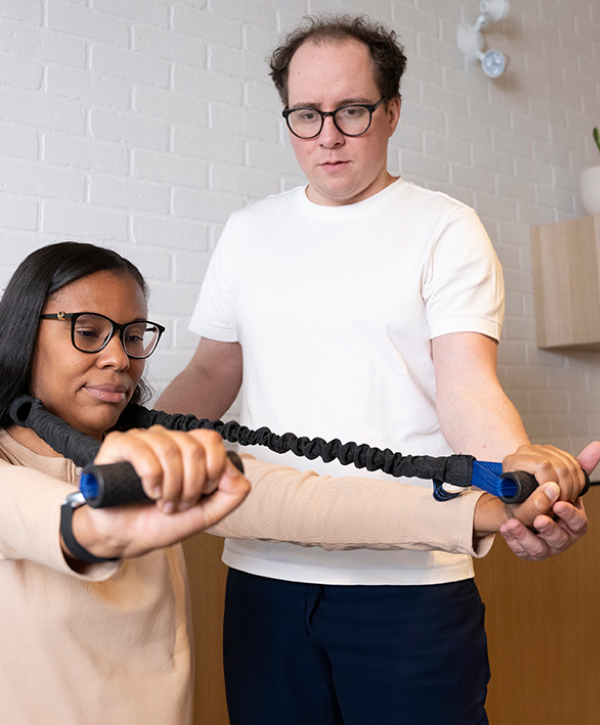 Chiropractor practices with client
