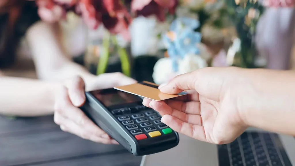 Person making a contactless payment to a card reader