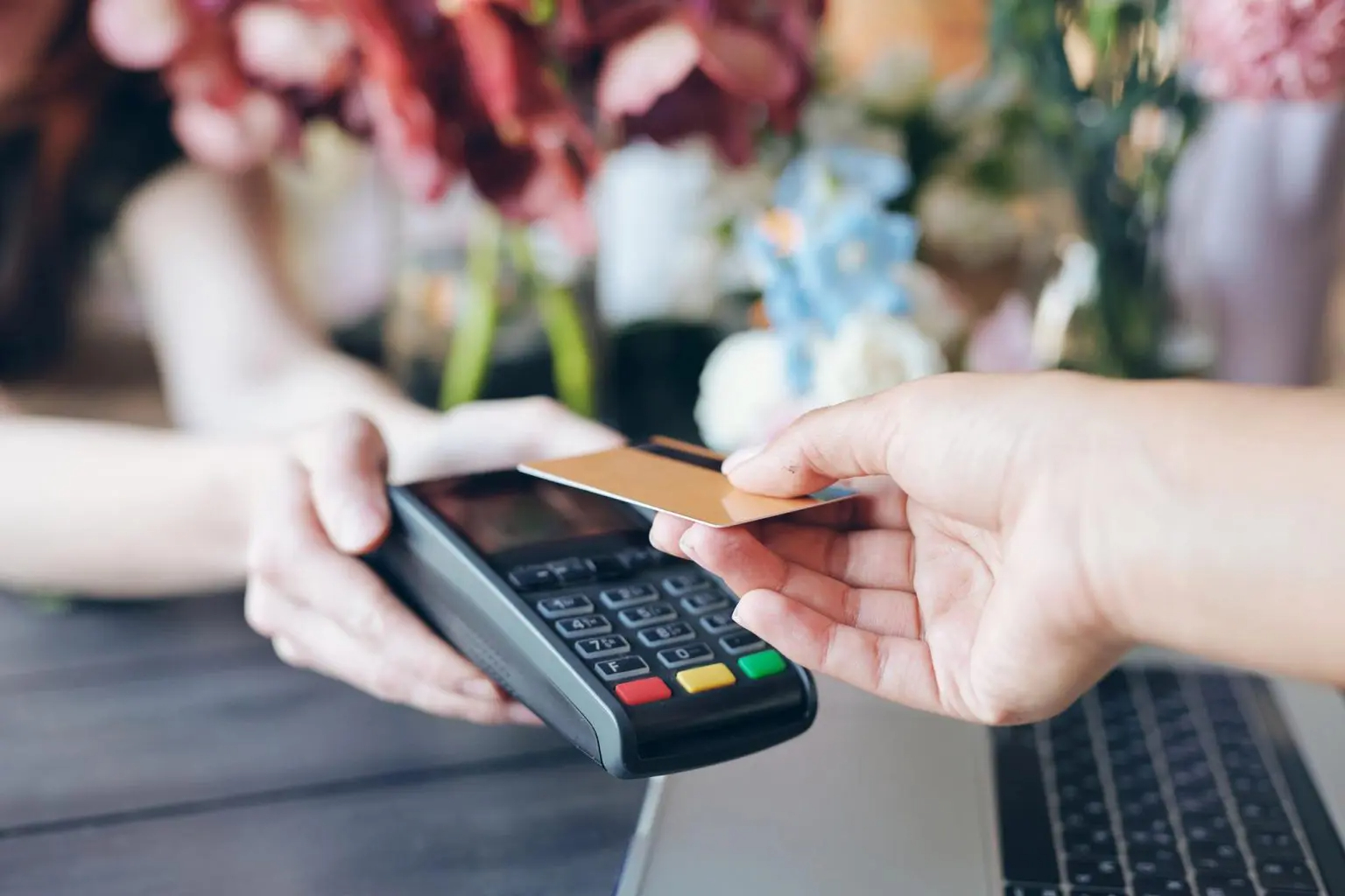 Person making a contactless payment to a card reader