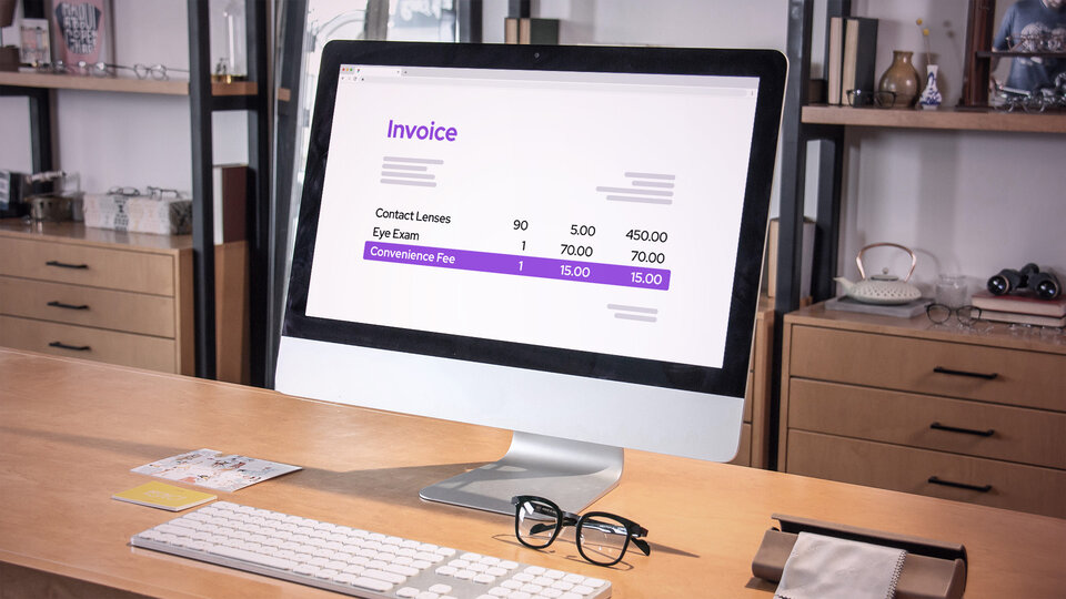 Desktop POS system with invoice displayed on the screen. Invoice shows an itemized list of the total including products, services and finally the convenience fee listed as a separate item.