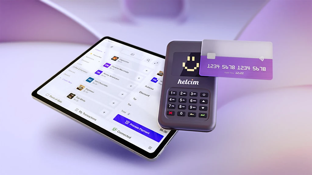 A credit card reader surrounded by credit cards and a POS device