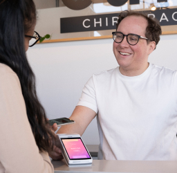 [A buisness owner accepts an in-person payment with the Helcim Smart Terminal