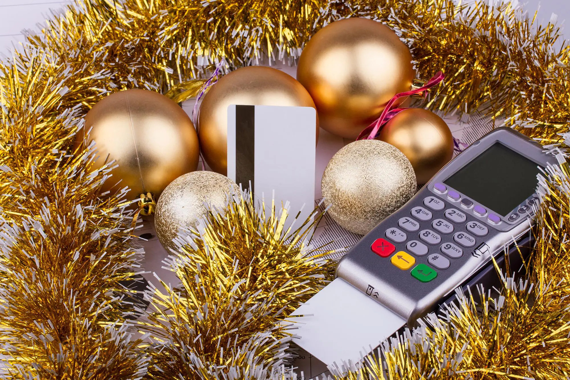 Christmas decorations surrounding a card reader and a credit card