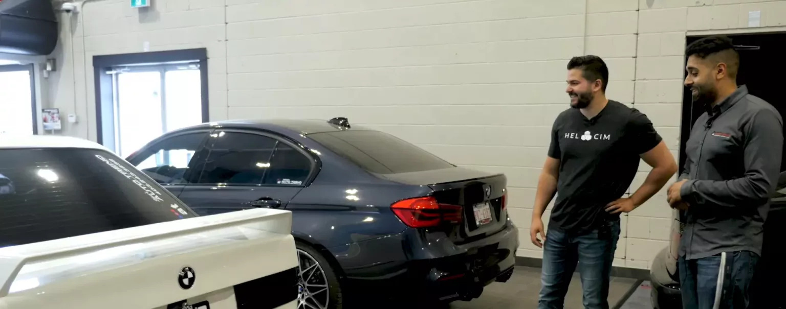 Nic standing next to automobiles