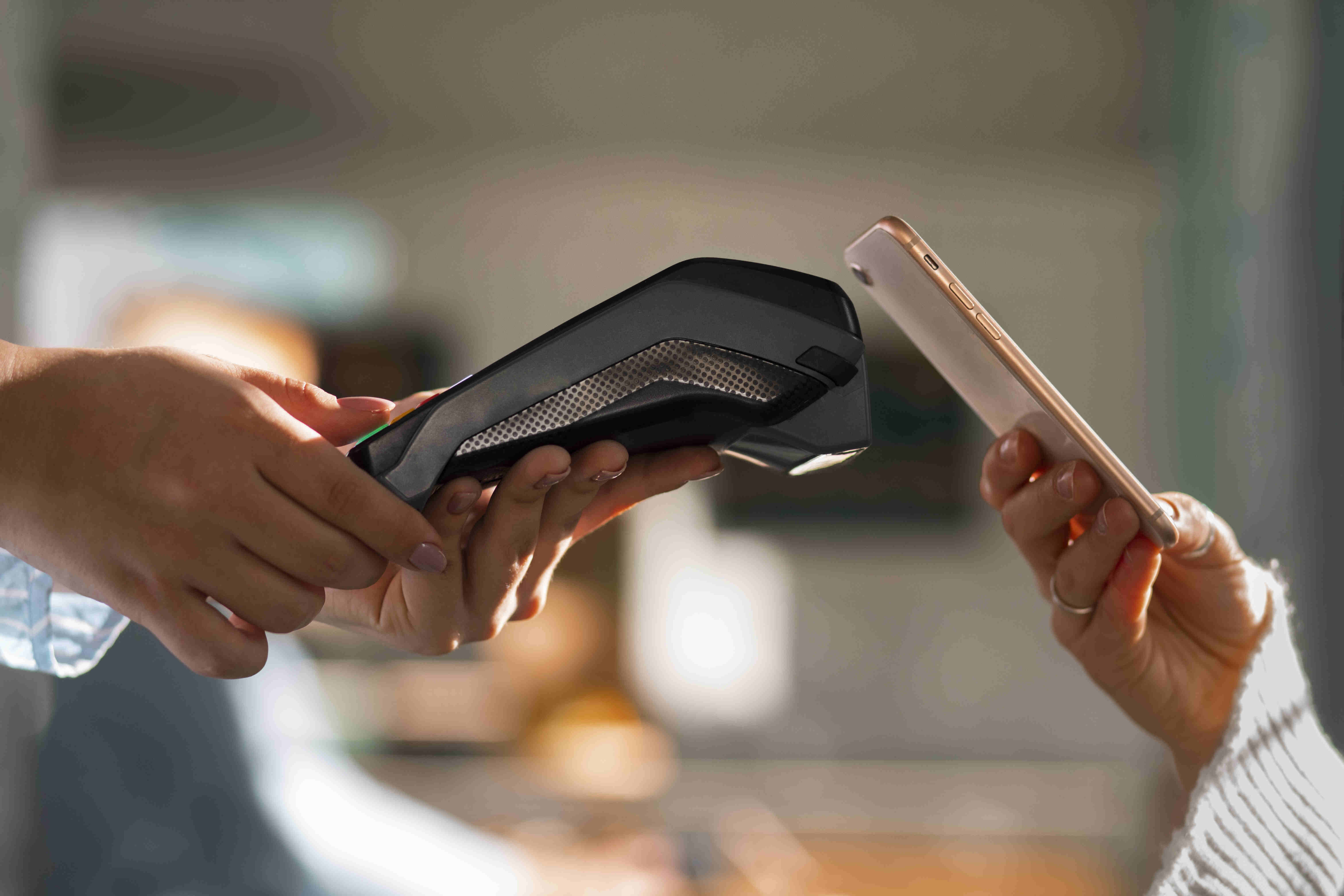 A person paying with nfc technology in a restaurant
