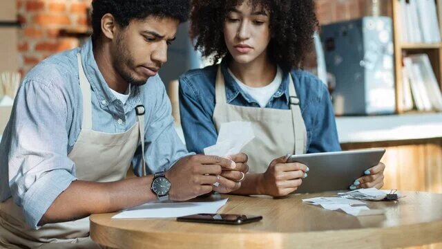 male and female business owners inspecting a chargeback request