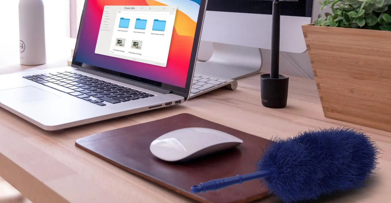 Laptop on a desk next to a duster