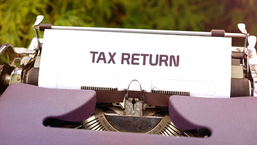 Tax return document in typewriter - Photo courtesy of Markus Winkler from Unsplash